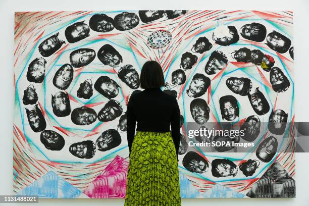 Woman is seen viewing Tillman Kaiser's artwork titled "City of the Week Heart" at the Saatchi Gallery during the exhibition. Kaleidoscope at the...