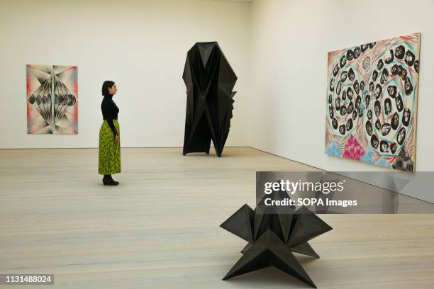 Woman is seen viewing Tillman Kaiser's artwork titled "City of the Week Heart" at the Saatchi Gallery during the exhibition. Kaleidoscope at the...