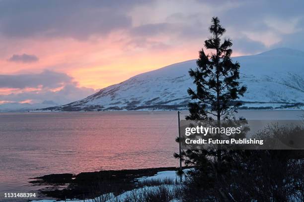 The sun sets behind a hill, Troms fylke, Norway, March 9, 2019. Ukrinform.