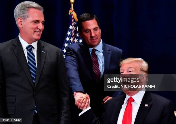 In this file photo taken on October 19, 2018 US President Donald Trump shakes hands with US Representative Devin Nunes as House Majority Leader Kevin...