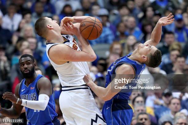 Nikola Jokic of the Denver Nuggets battles for the ball against Dwight Powell of the Dallas Mavericks in the second half at American Airlines Center...