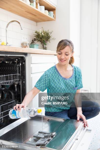 woman using white vinegar. - white vinegar stock pictures, royalty-free photos & images