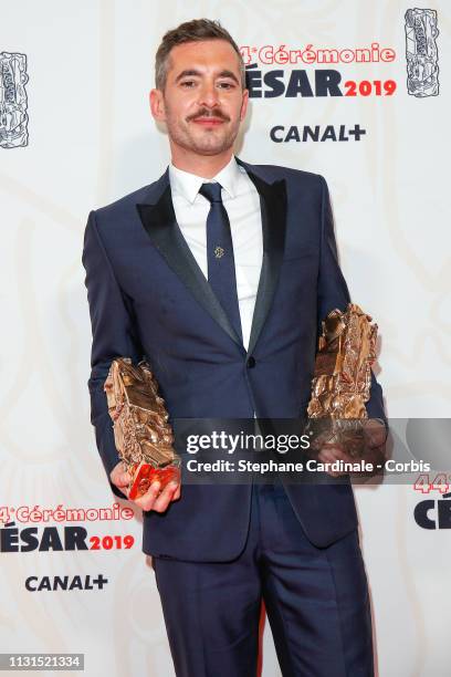 Xavier Legrand poses with the Cesars for Best Film award and Best Original Screenplay awards for the film ''Jusqu'a la garde'’ during the Cesar Film...
