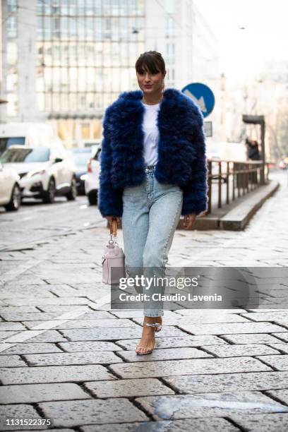 Carlotta Rubaltelli, wearing blue fur coat, white t-shirt, white tod's bag and jeans, is seen outside Blumarine on Day 3 Milan Fashion Week...