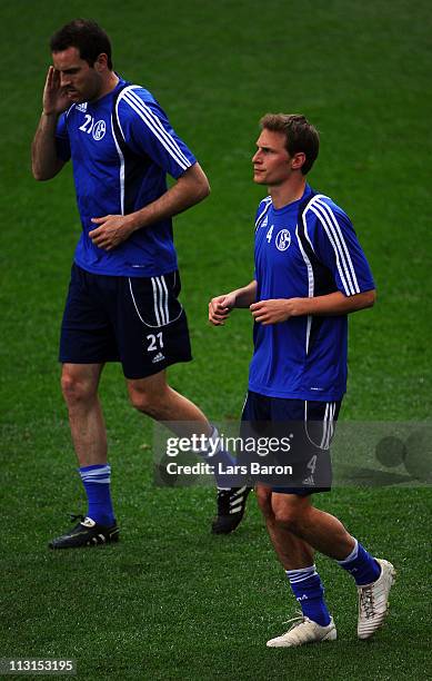 Benedikt Hoewedes warms up with team mate Christoph Metzelder during a FC Schalke 04 training session ahead of the UEFA Champions League semifinal...