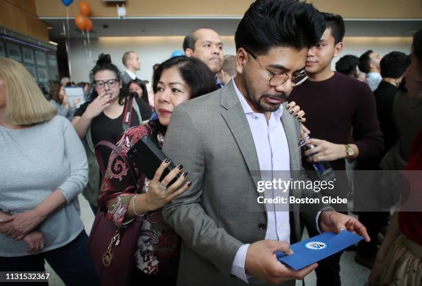 Veth Huorn leans against her son Steven Emas he waits to open his match letter during Match Day at University of Massachusetts Medical School in...