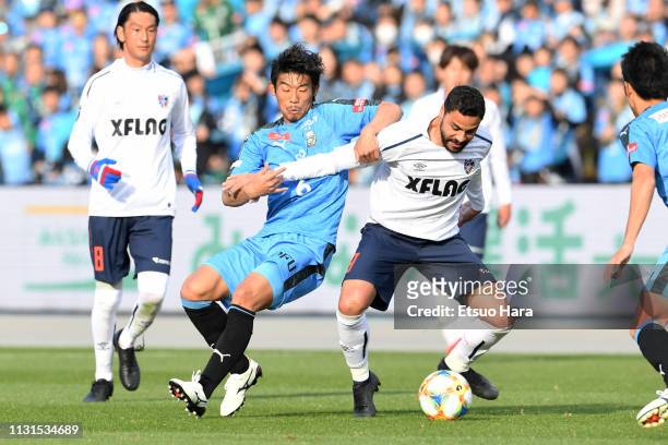 Hidemasa Morita of Kawasaki Frontale and Diego Oliveira of FC Tokyo compete for the ball during the J.League J1 match between Kawasaki Frontale and...