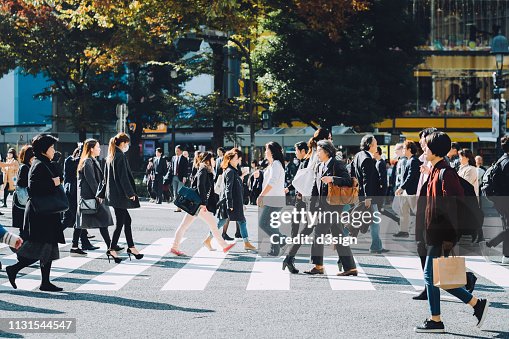 Crowd of busy commuters crossing street in Shibuya crossroad, Tokyo Crowd of busy commuters crossing street in Shibuya crossroad, Tokyo