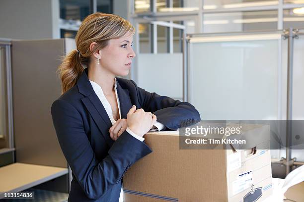 woman with moving boxes in office, thinking - downsizing unemployment bildbanksfoton och bilder