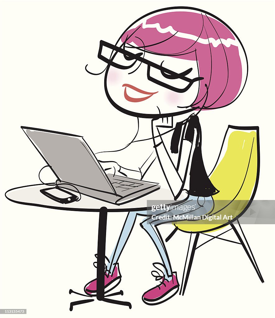 Young woman using laptop and listening to music