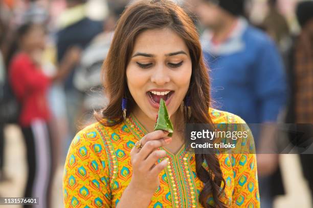 woman eating betel leaf - eating spicy food stock pictures, royalty-free photos & images