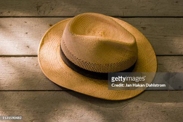 panama hat hanging on wall - straw hat stock pictures, royalty-free photos & images