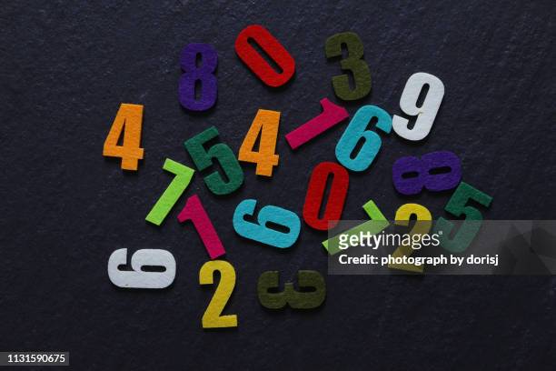 colorful numbers on dark background - numbers stock pictures, royalty-free photos & images