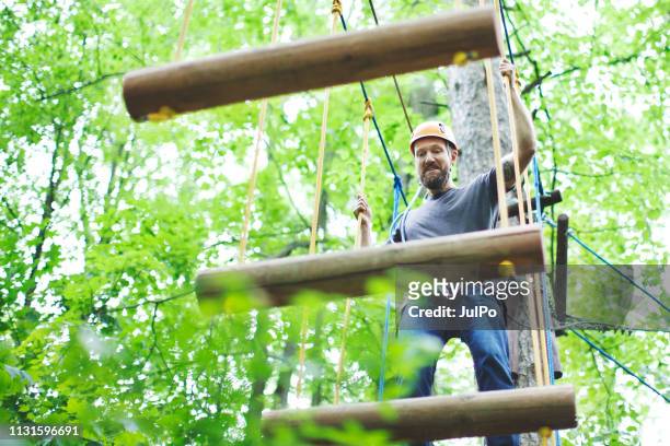 man on zip line - eco tourism stock pictures, royalty-free photos & images