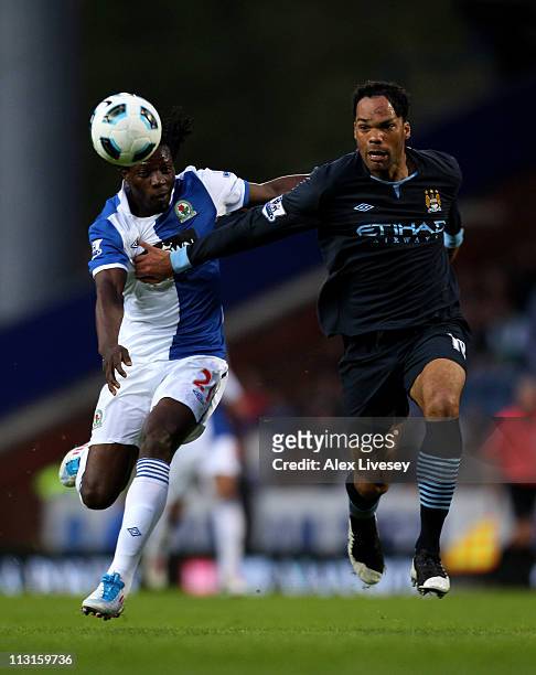 Joleon Lescott of Manchester City competes with Benjani of Blackburn Rovers during the Barclays Premier League match between Blackburn Rovers and...