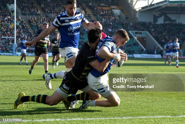Alex Mitchell of Northampton Saints tackles of Ruaridh McConnochie Bath Rugby as he scores their first try during the Gallagher Premiership Rugby...
