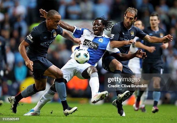 Vincent Kompany and Pablo Zabaleta of Manchester City challenge Benjani of Blackburn Rovers during the Barclays Premier League match between...