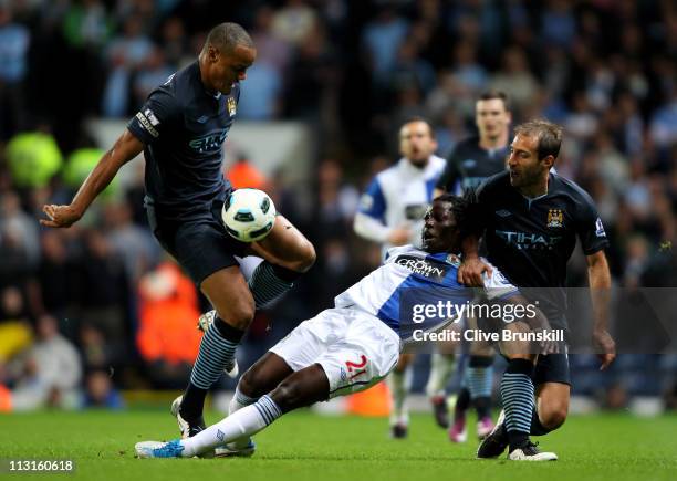 Vincent Kompany and Pablo Zabaleta of Manchester City challenge Benjani of Blackburn Rovers during the Barclays Premier League match between...
