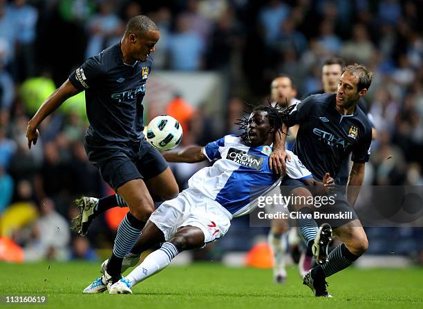 Vincent Kompany and Pablo Zabaleta of Manchester City challenge Benjani of Blackburn Rovers during the Barclays Premier League match between...