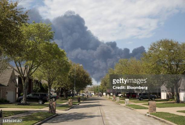 Plume of smoke rises above homes following a fire at the Intercontinental Terminals Co petrochemical storage site in Deer Park, Texas, U.S., on...