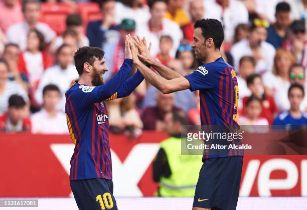 Lionel Messi of FC Barcelona celebrates with his teammates Sergio Busquets of FC Barcelona after scoring his team's third goal during the La Liga...