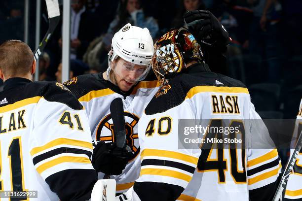Tuukka Rask and Charlie Coyle of the Boston Bruins celebrate their teams 5-0 win over the New York Islanders at NYCB Live's Nassau Coliseum on March...