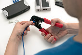 Technician using network cable crimper