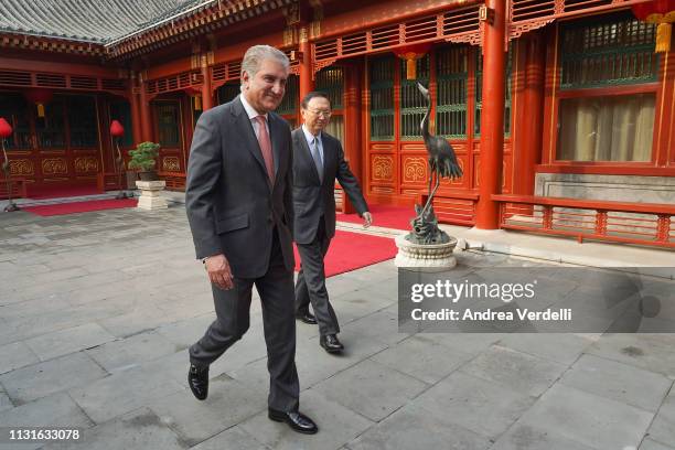 Chinese Director of the Central Foreign Affairs Commission Office Yang Jiechi and Pakistani Foreign Minister Shah Mehmood Qureshi walk into the...