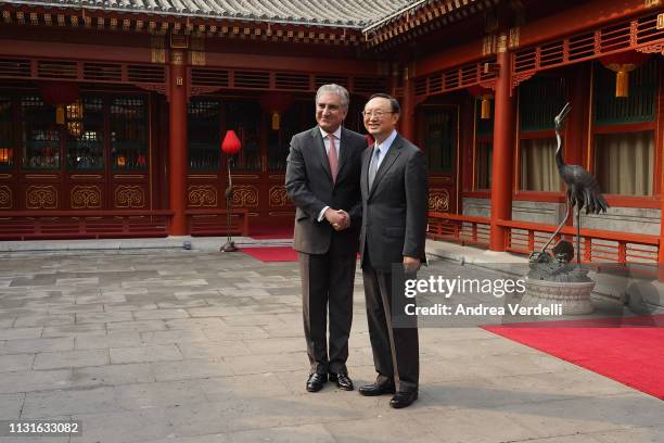 Chinese Director of the Central Foreign Affairs Commission Office Yang Jiechi shakes hands with Pakistani Foreign Minister Shah Mehmood Qureshi at...