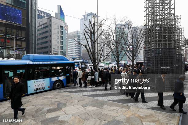 Shareholders stand in line to enter the Samsung Electronics Co. Annual general meeting outside the company's Seocho office building in Seoul, South...
