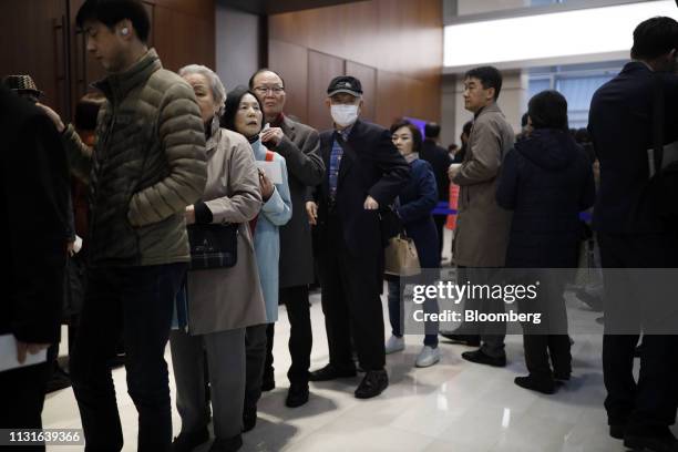 Shareholders stand in line for the Samsung Electronics Co. Annual general meeting at the company's Seocho office building in Seoul, South Korea, on...