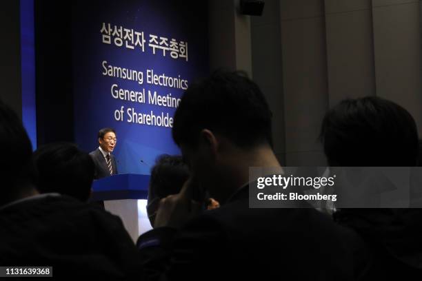 Shareholders listen to Kim Ki-nam, president and co-chief executive officer of Samsung Electronics Co., speaking during the company's annual general...