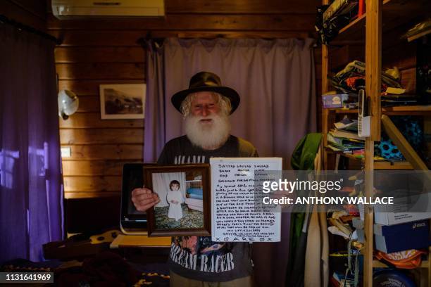 In this photo taken on March 19, 2019 in Lyttelton, close to Christchurch, local resident John Milne weeps as he stands in the bedroom of his...