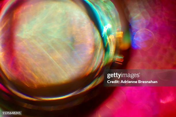 glass sphere against pink background - yule marble stock pictures, royalty-free photos & images