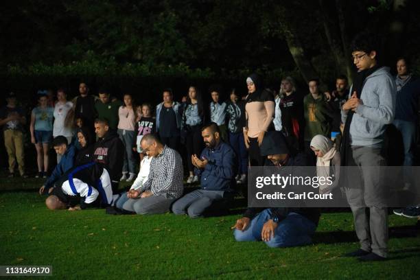 Muslims pray in a park near Al Noor mosque on March 20, 2019 in Christchurch, New Zealand. 50 people were killed, and dozens are still injured in...