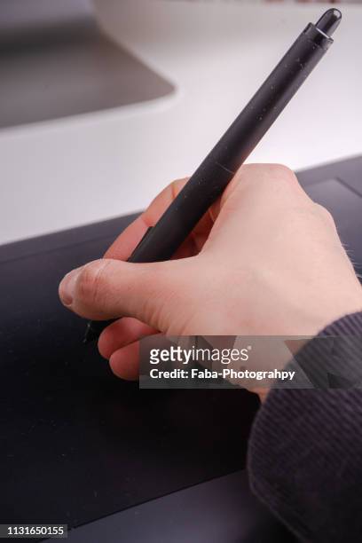 close-up on hands male designer. working on graphic tablet in modern space office - geschäftsleben foto e immagini stock