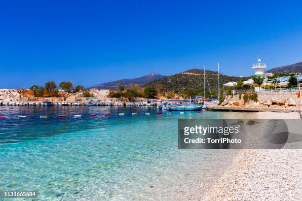 mediterranean sea beach with blue water, yacht mooring and lighthouse - antalya stock pictures, royalty-free photos & images