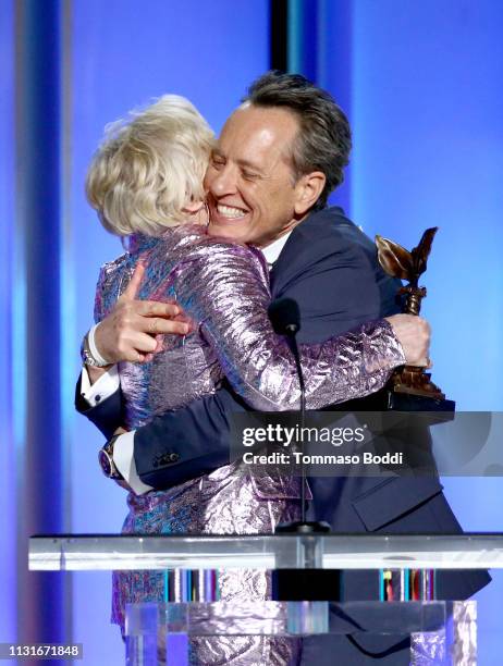 Richard E. Grant accepts Best Supporting Male for “Can You Ever Forgive Me?” from Glenn Close onstage during the 2019 Film Independent Spirit Awards...