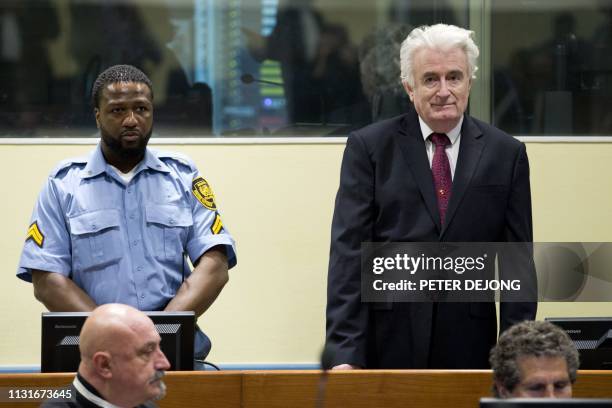 Former Bosnian Serb leader Radovan Karadzic looks on as he arrives at the court room of the International Residual Mechanism for Criminal Tribunals...