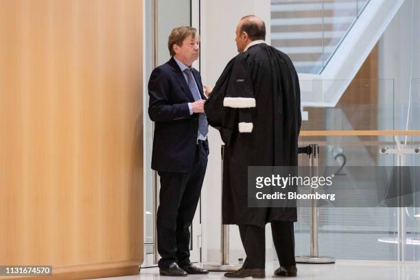 Maurice Lantourne, a former lawyer for French businessman Bernard Tapie, left, speaks with Herve Temime, lawyer, in the hallway at Porte de Clichy...