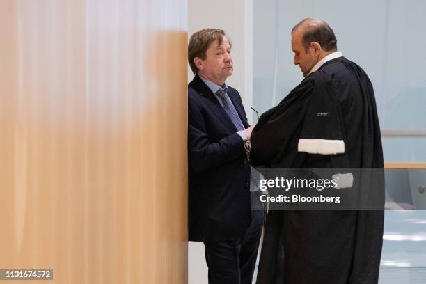 Maurice Lantourne, a former lawyer for French businessman Bernard Tapie, left, speaks with Herve Temime, lawyer, in the hallway at Porte de Clichy...