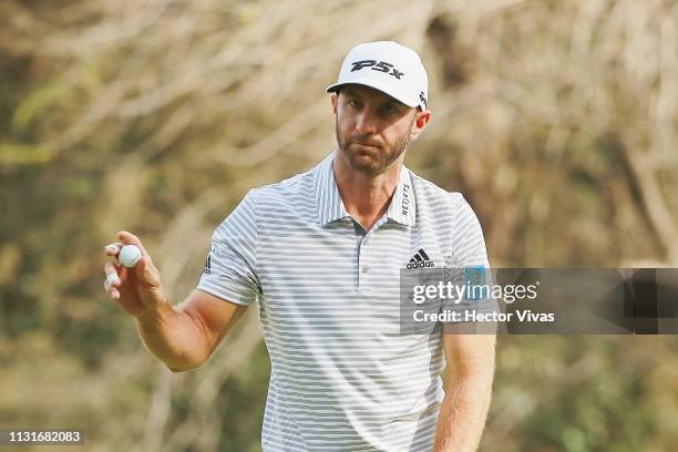 Dustin Johnson of the United States acknowledges the crowd on the 14th green during the third round of World Golf Championships-Mexico Championship...