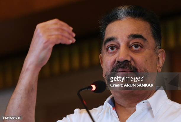 Indian cinema actor and founder of 'Makkal Needhi Mayyam' party Kamal Hassan gestures as he speaks during the candidates introduction event ahead of...