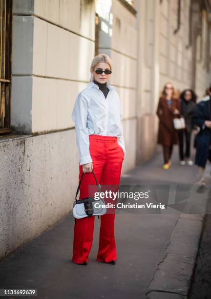 Caroline Caro Daur wearing red pants, Prada bag is seen outside