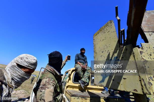 Fighters with the Syrian Democratic Forces gather near the village of Baghouz in the countryside of the eastern Syrian province of Deir Ezzor on...