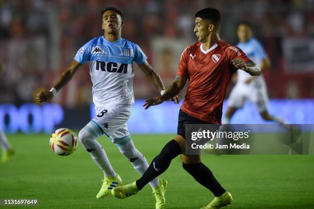 Federico Zaracho of Racing Club fights for the ball with Pablo Hernandez of Independiente during a match between Independiente and Racing Club as...