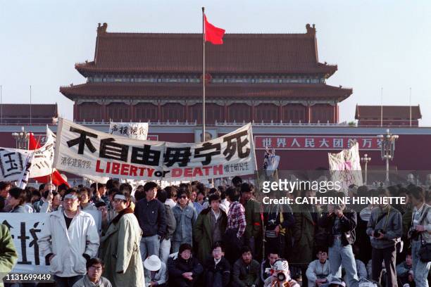 Students and local people gathered at Tiananmen Square in Beijing on May 14, 1989 after an over-night hunger strike as part of the mass pro-democracy...