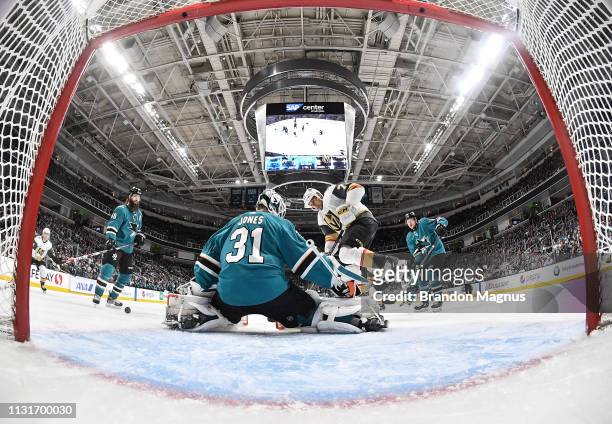 Martin Jones of the San Jose Sharks defends the net against Ryan Reaves of the Vegas Golden Knights at SAP Center on March 18, 2019 in San Jose,...