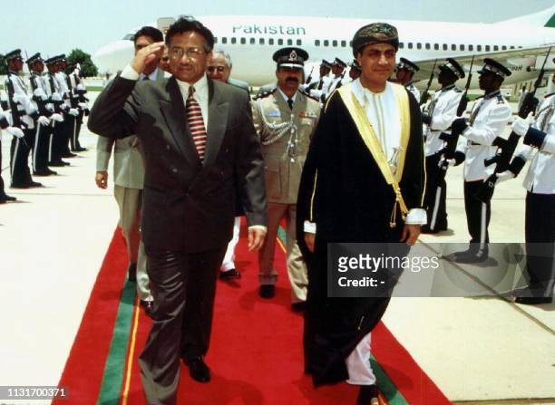 Pakistani military ruler General Pervez Musharraf salutes an honor guard upon his arrival in Muscat for a two-day visit 11 June 2000. Pervez is...