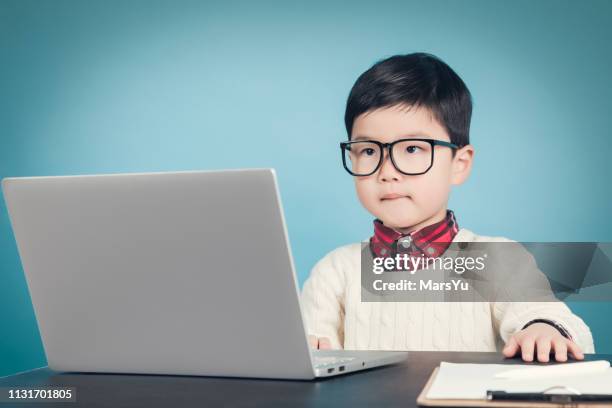 young nerd boy using laptop - adult imitation stock pictures, royalty-free photos & images